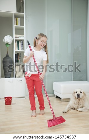 Girl sweeping the floor