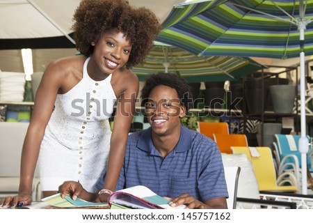 Young African American couple buying Outdoor furniture at Store