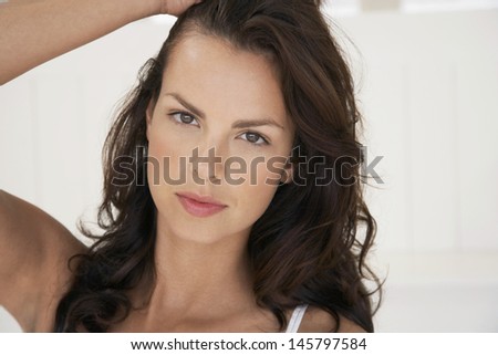 Portrait of sexy young woman with hand in hair