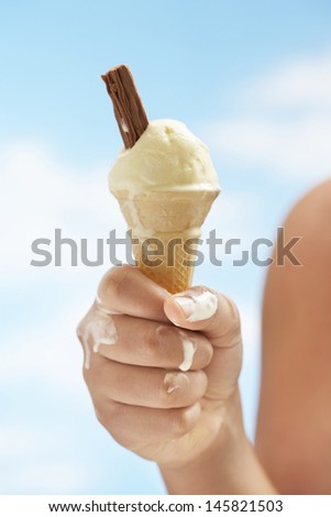 Closeup of girl holding cone icecream outdoors