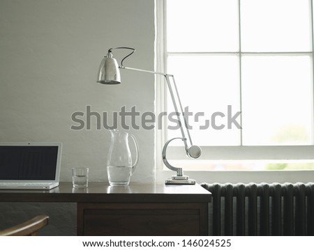 Closeup view of a study desk with laptop and lamp