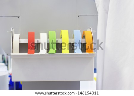 Closeup of rolls of multicolored labeling tape in laboratory