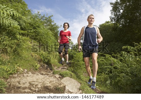 Low angle view of a couple hiking down on trail