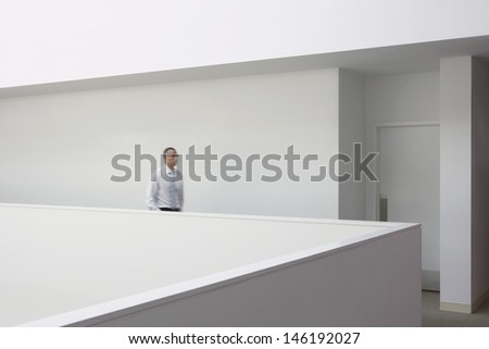 Side view of a businessman walking through office hallway