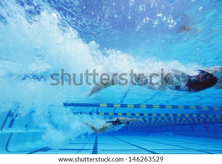 Young Caucasian female swimmers swimming in pool