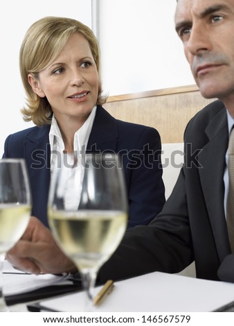 Middle aged business people in meeting at restaurant