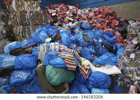 Piles of rubbish bin bags at recycling plant