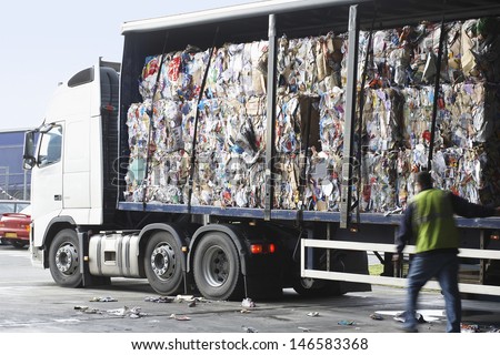 Stacks of recycled paper in lorry at recycling plant