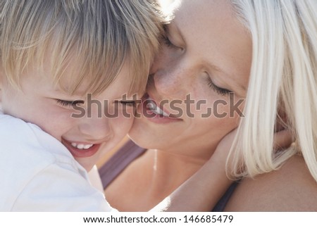 Closeup of playful young woman with son
