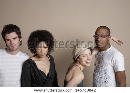 Portrait of young multiethnic friends standing on colored background