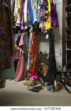 Crowded Clothing Racks And Piled Shoes In Second Hand Store