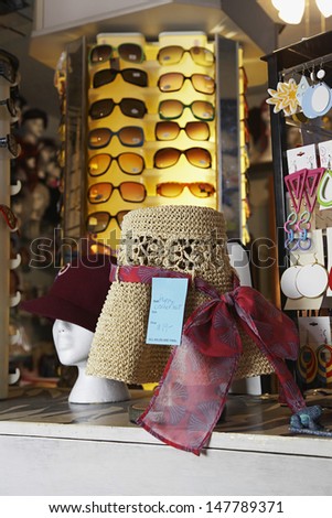 Closeup of hats and sunglasses on display at second hand store