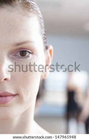 Closeup portrait of beautiful young woman in ballet rehearsal room