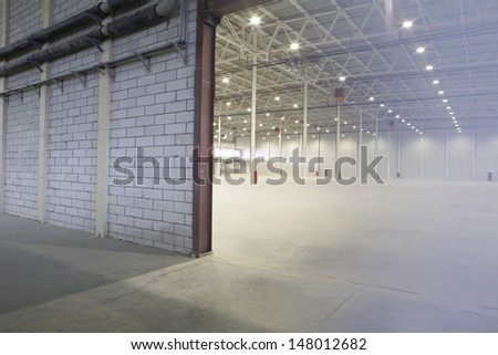 Access door to brightly lit and empty warehouse