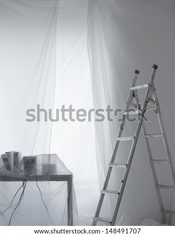 Desk covered in transparent dust sheets in preparation for decoration