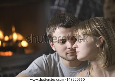 Closeup of loving young man looking at woman in house