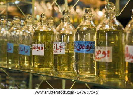 Closeup of bottles of essential oils used in perfume making displayed in a row