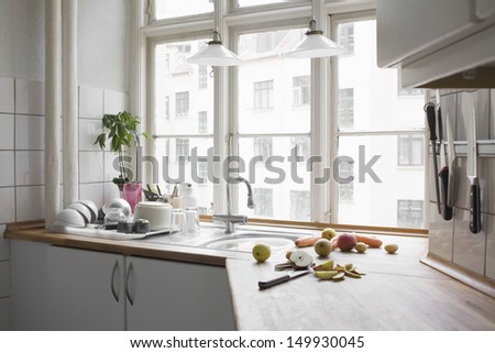Kitchen worktop with chopped fruit and vegetables in urban apartment