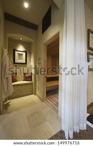 View of curtained sauna and steam room at modern home