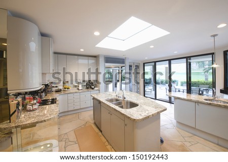 View Of Marble Topped Worktop Units In Modern Kitchen At Home