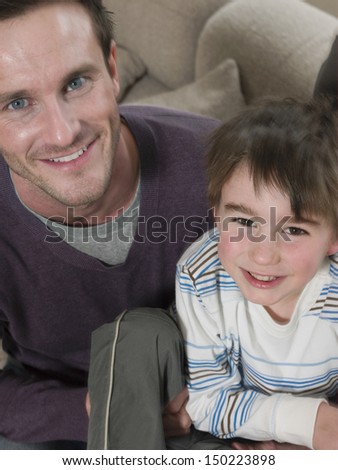 High angle portrait of happy father and son at home