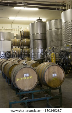 Fermentation tanks and barrels of wine in cellar