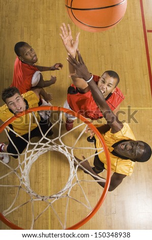 High Angle View Of Basketball Player Attempting To Slam Dunk Ball