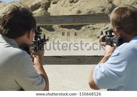 Men aiming rifles at firing range