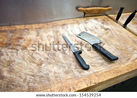 Butcher knife on cutting board in supermarket