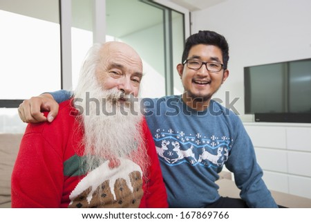 Portrait of grandson and grandfather smiling in house