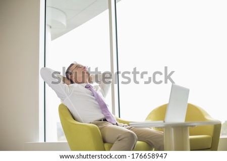 Mature businessman relaxing in lobby
