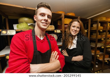 Portrait of confident store clerks in cheese shop