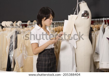 Side view of woman working in her clothing store