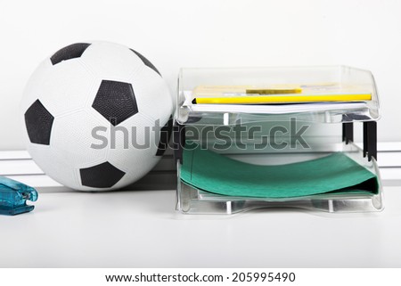 Soccer ball near file rack at desk