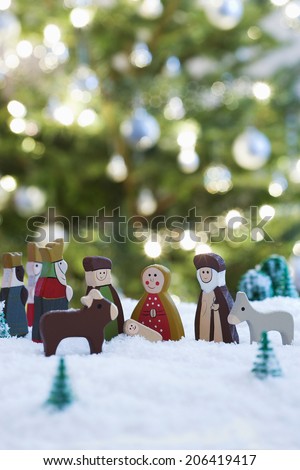 Nativity scene of Jesus birth with Christmas tree in background