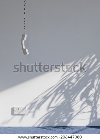 View of a telephone receiver hanging against wall in empty room