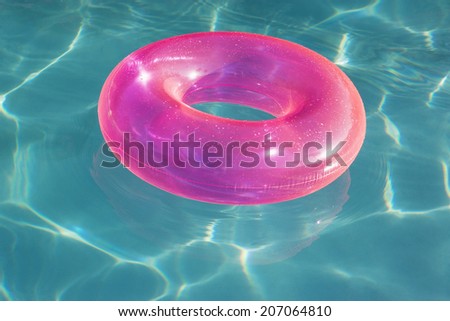 Pink Float Tube Floating in Swimming Pool