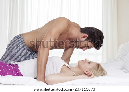 Side view of passionate young couple in bed