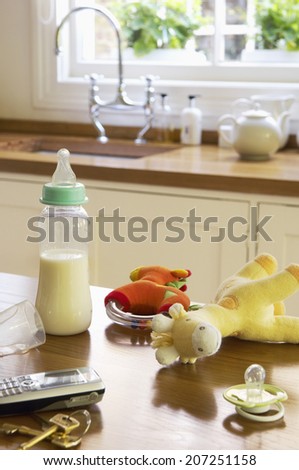 Closeup of baby Items on kitchen counter by cellphone and keys