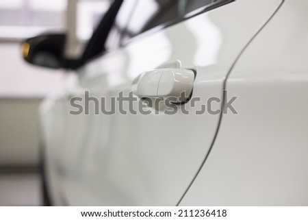 Close-up of white car in repair store
