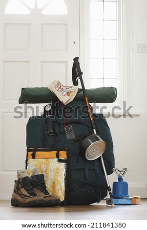 Backpack and camping equipment in hallway