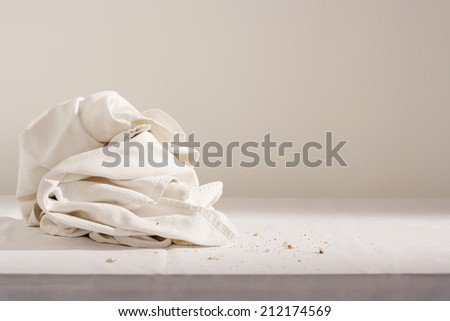 Dish cloth and crumbs on table