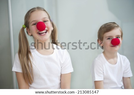 Portrait of children wearing clown noses