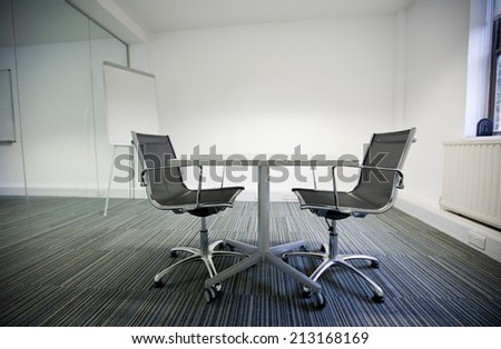 Side view of small table and two chairs in office
