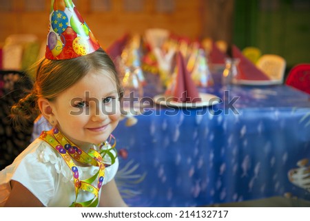 Young girl seated at her birthday table