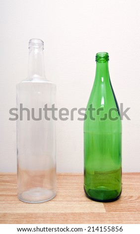 one green glass bottle and one clear glass bottle
