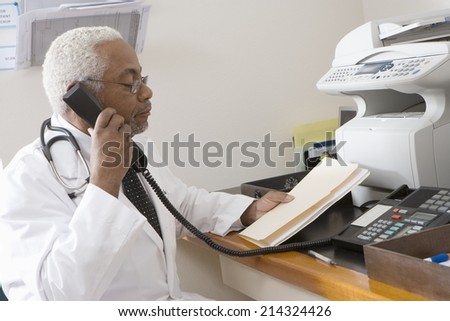 Senior medical practitioner on phone with hospital records