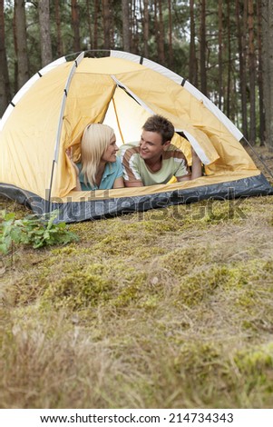 Romantic young couple camping in forest