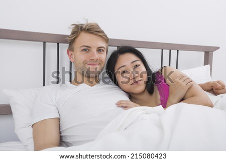 Portrait of loving couple in bed