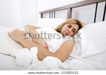 Woman suffering from abdomen pain in bed
